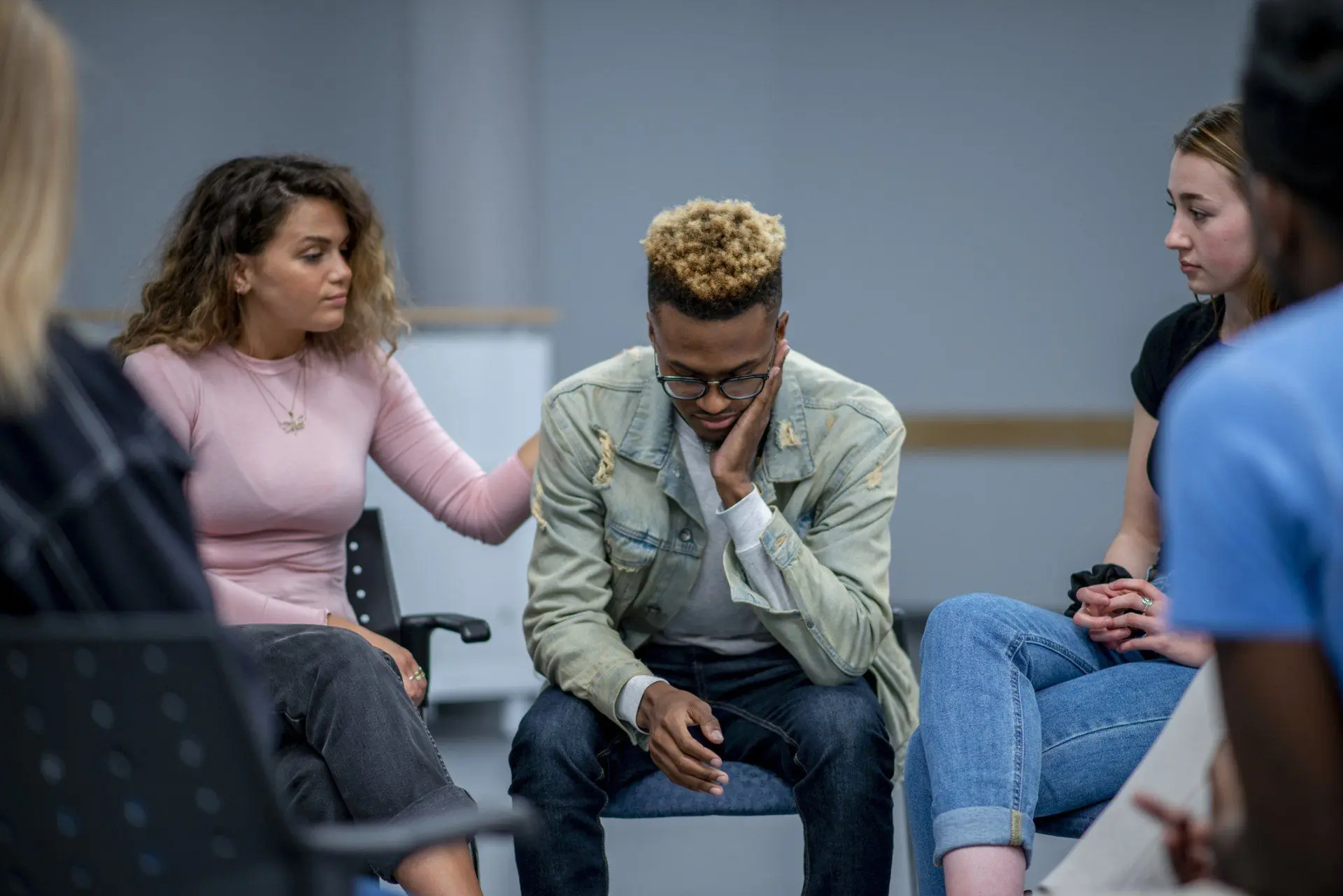 Supportive group comforting a friend